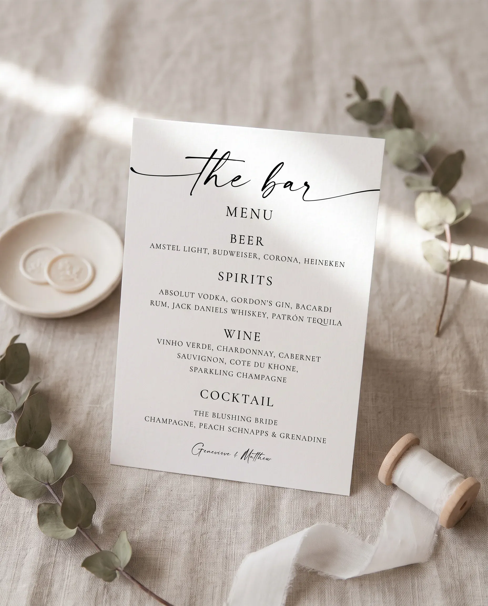 Arcadia — bar menu displayed upright in a styled setting under soft natural light with a slight overhead angle, wedding bar sign.