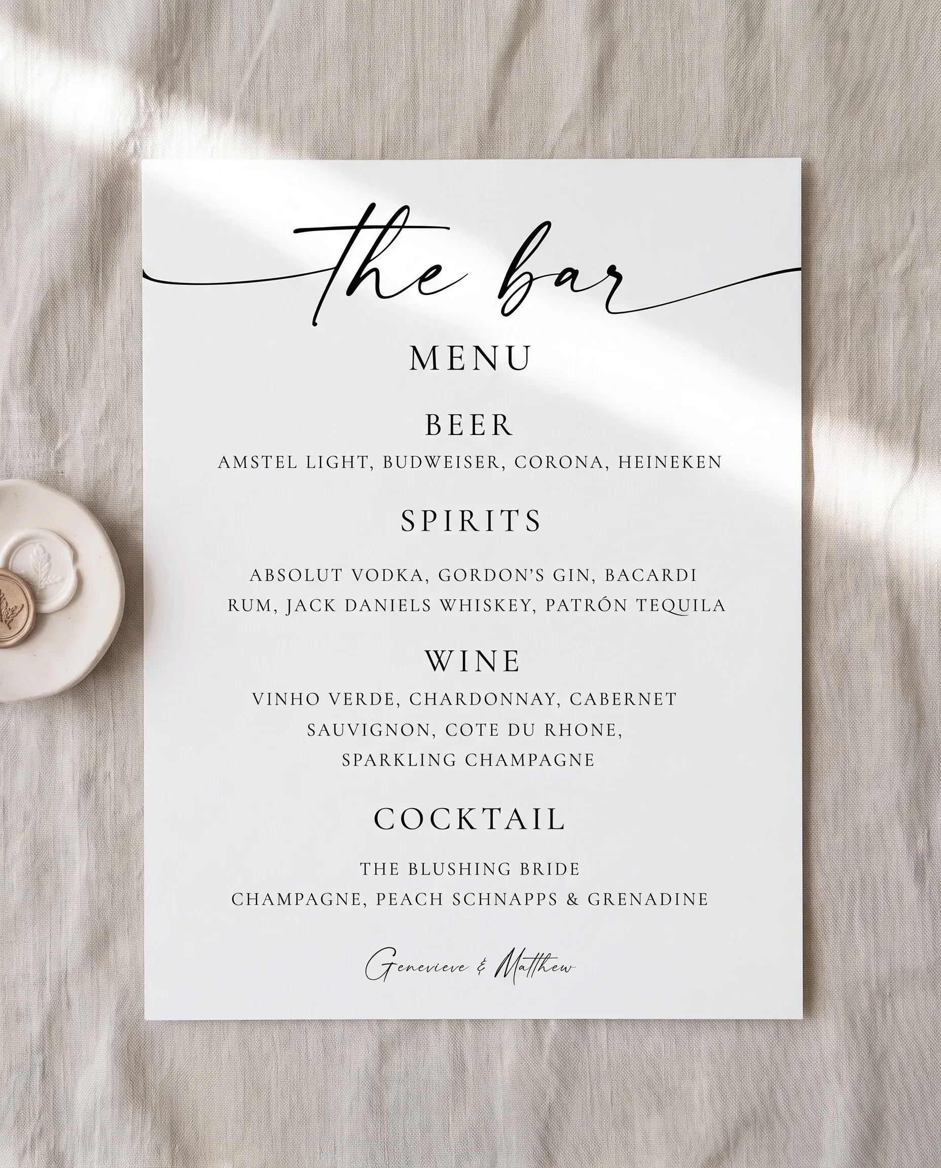 Arcadia — bar menu page lying flat under soft natural light with a slight overhead angle, wedding bar menu