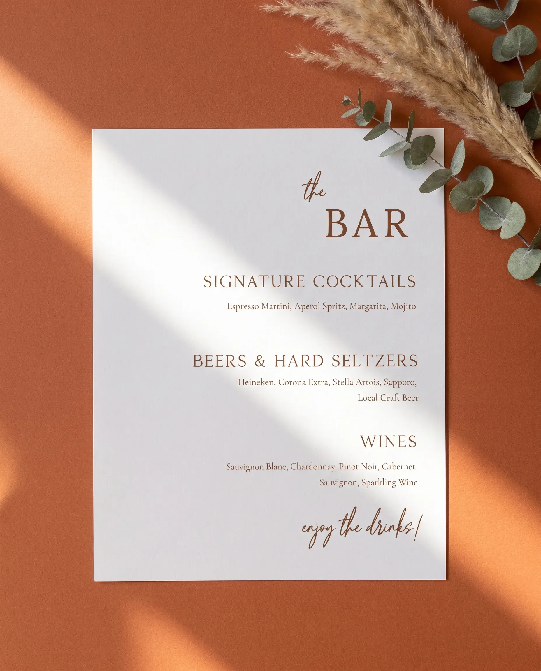 Briar Script — flat lay of the bar menu on premium editorial paper under soft natural light, slight overhead angle, wedding bar menu.