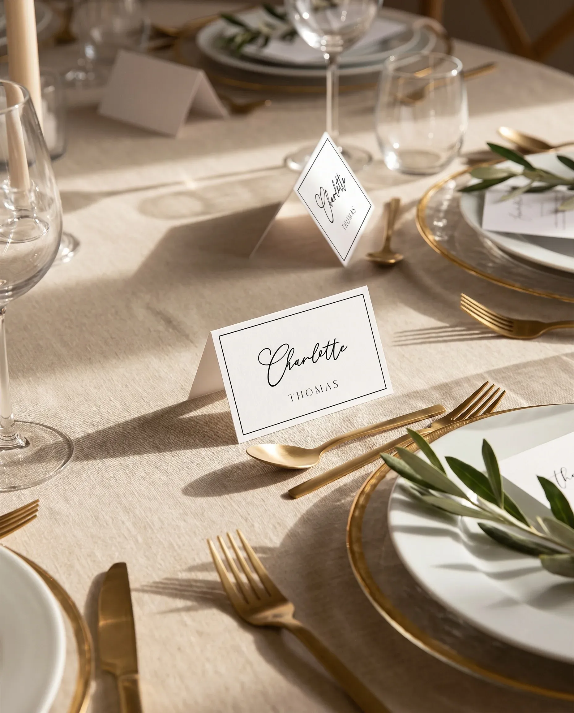 Aurelian wedding place cards — several cards arranged on a dressed reception table under soft natural light, place card template.