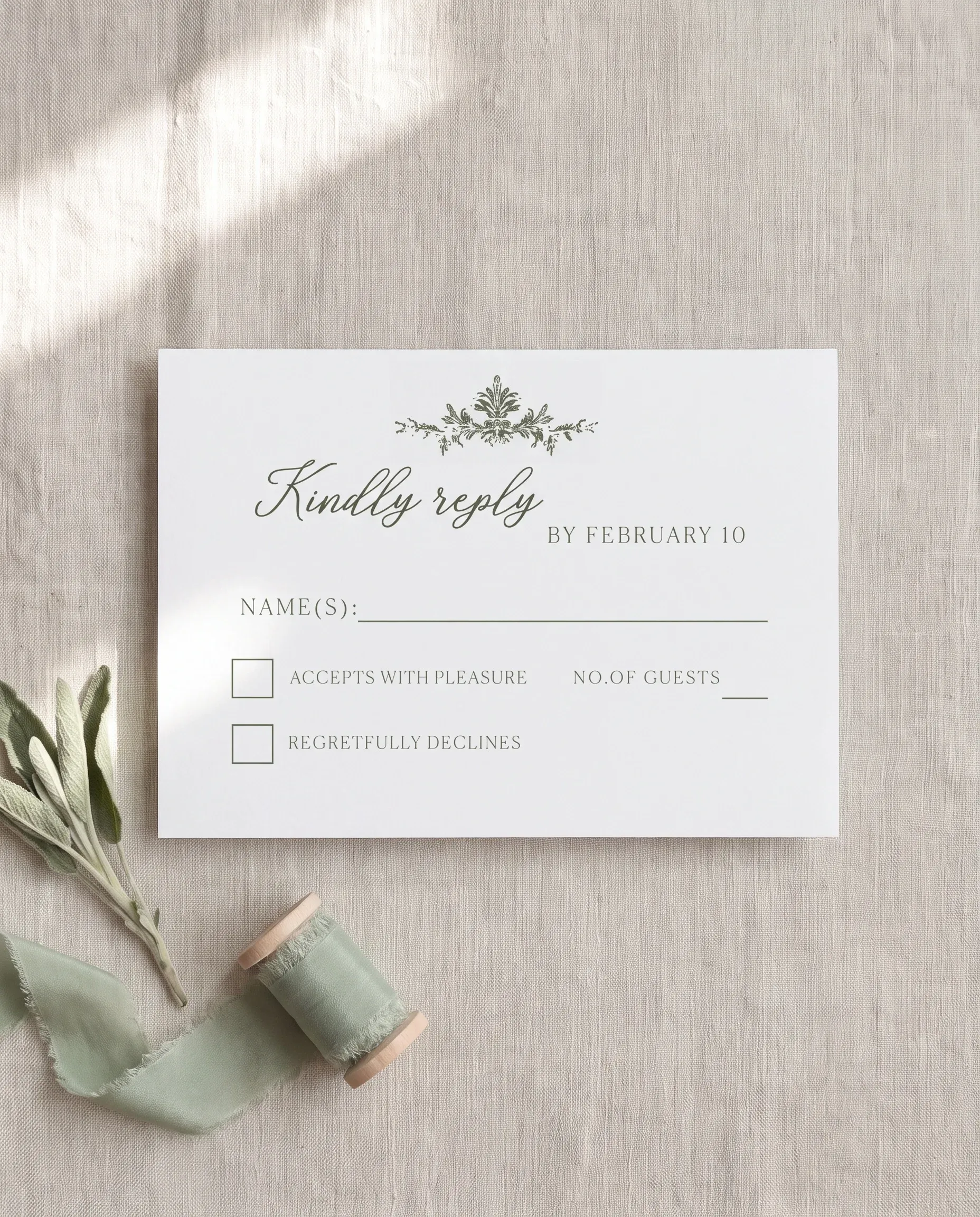 Sage Crest wedding invitation suite — RSVP card shown in a flat lay, photographed overhead on premium editorial paper, wedding RSVP cards.