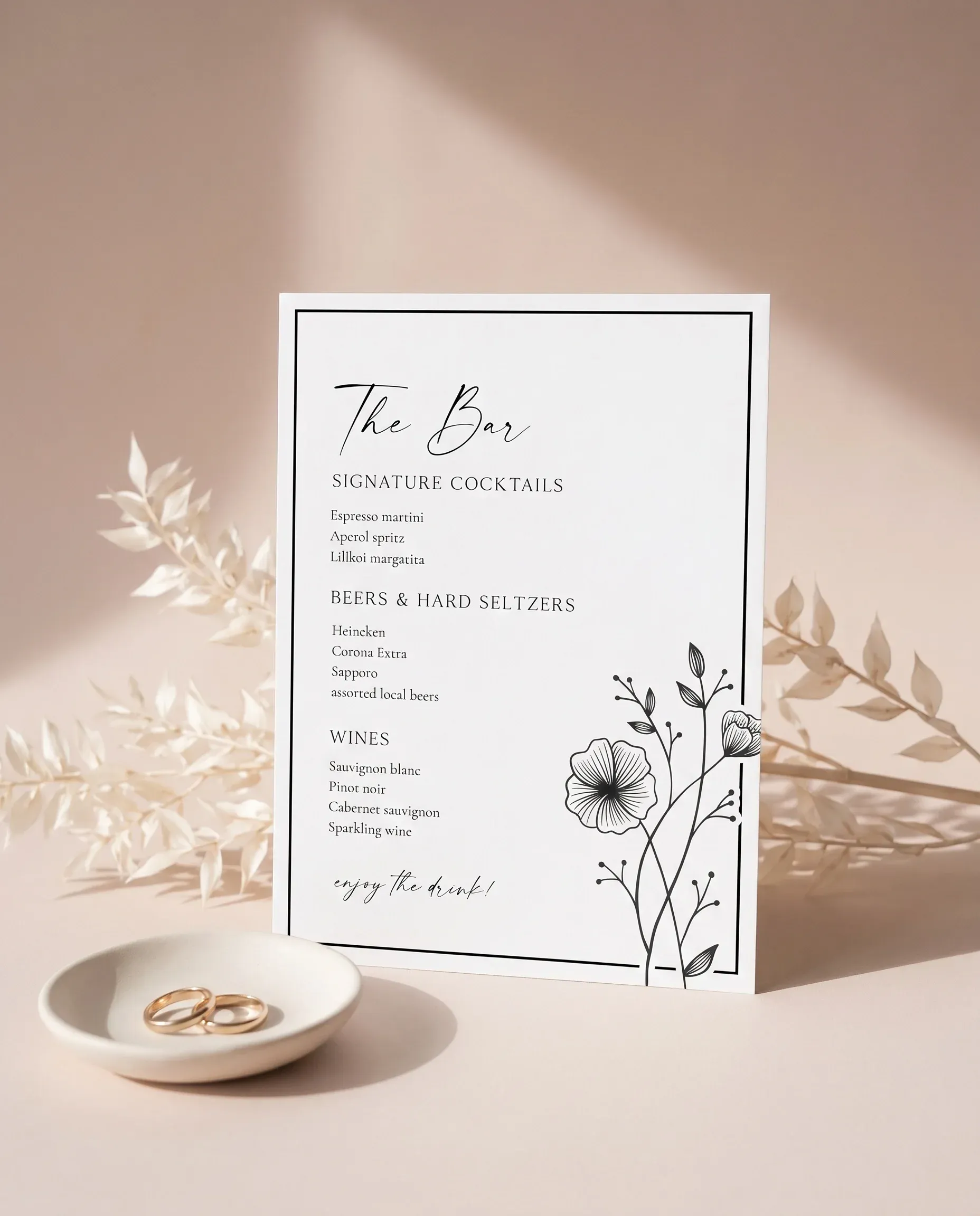 Hush Bloom — bar menu displayed upright at a slight overhead angle under soft natural light, wedding bar sign.