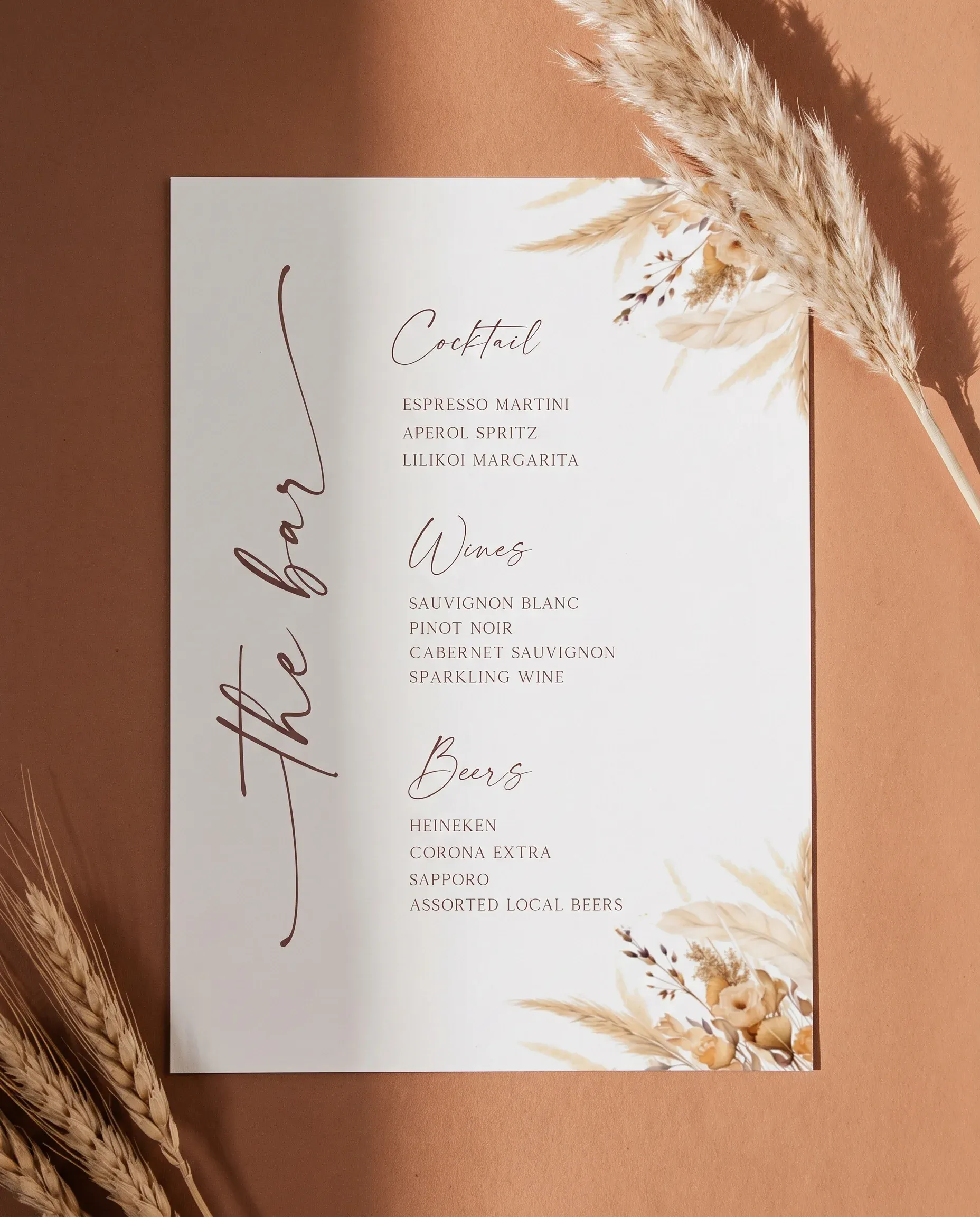 Harvest Script — bar menu page shown flat on premium editorial paper under soft natural light at a slight overhead angle, wedding bar menu.